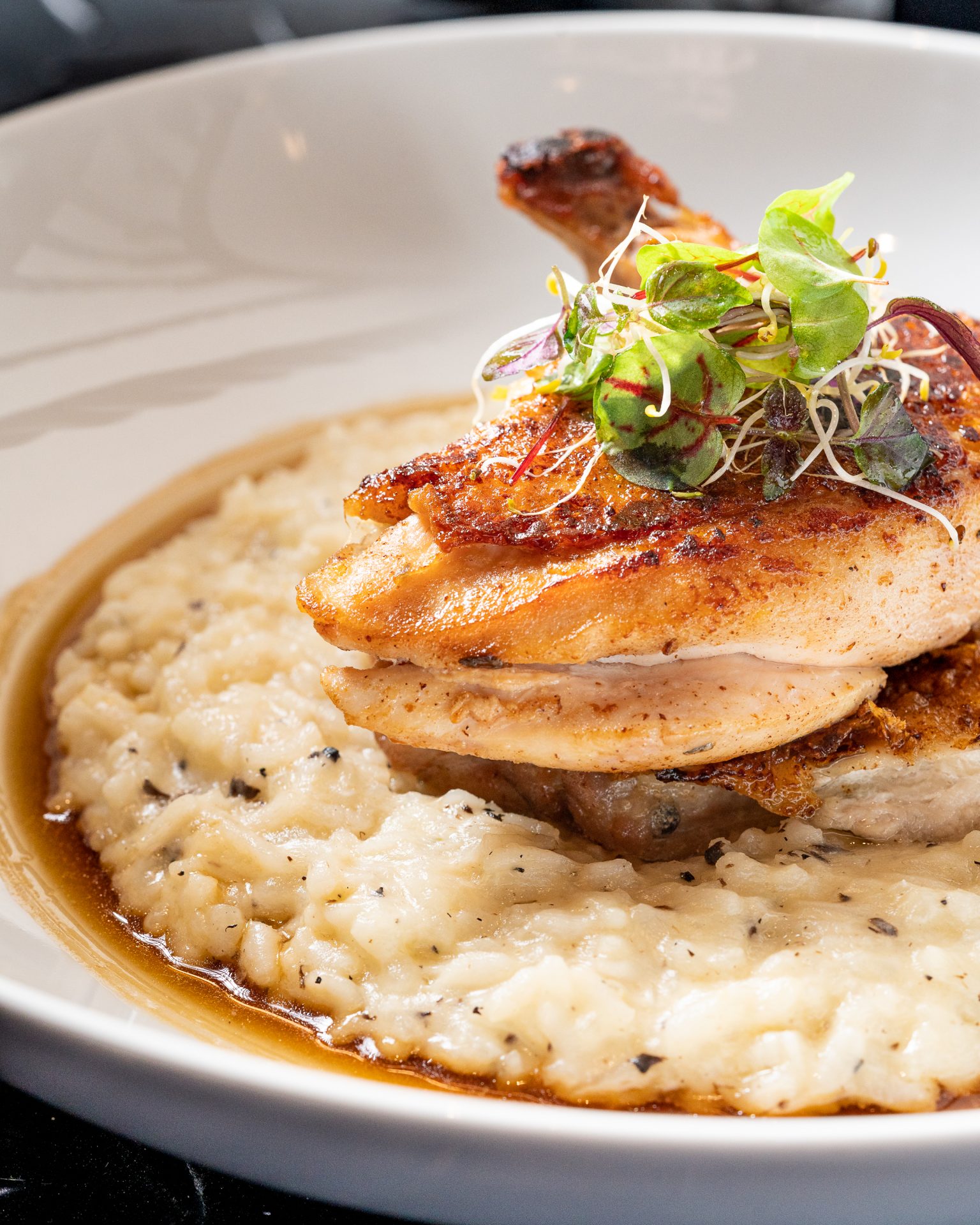 Fines Herbes Roast Baby Chicken with Truffle Risotto, Reggiano & Chicken Juices Dish Served at Raoul's Restaurant in Riyadh