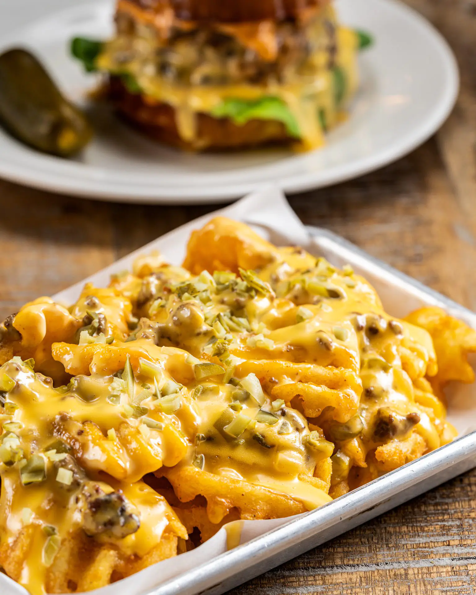 Waffle fries with chopped cheese add-on dish from Emmy Squared Pizza Fine Dining restaurant at Jeddah Yacht Club