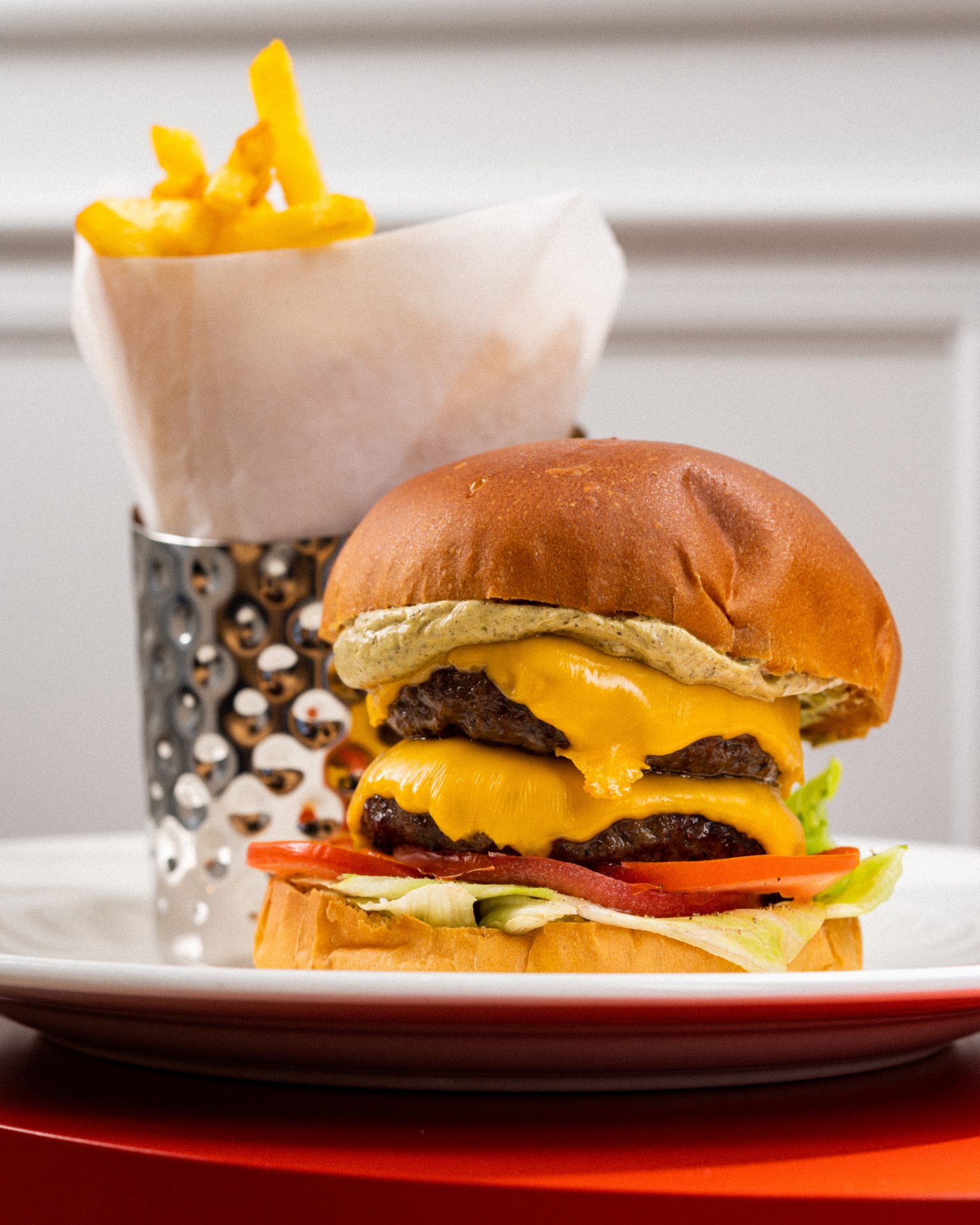 Double cheeseburger with French fries served by Le Comptoir De Nicole Fine Dining Restaurant - Jeddah Yacht Club